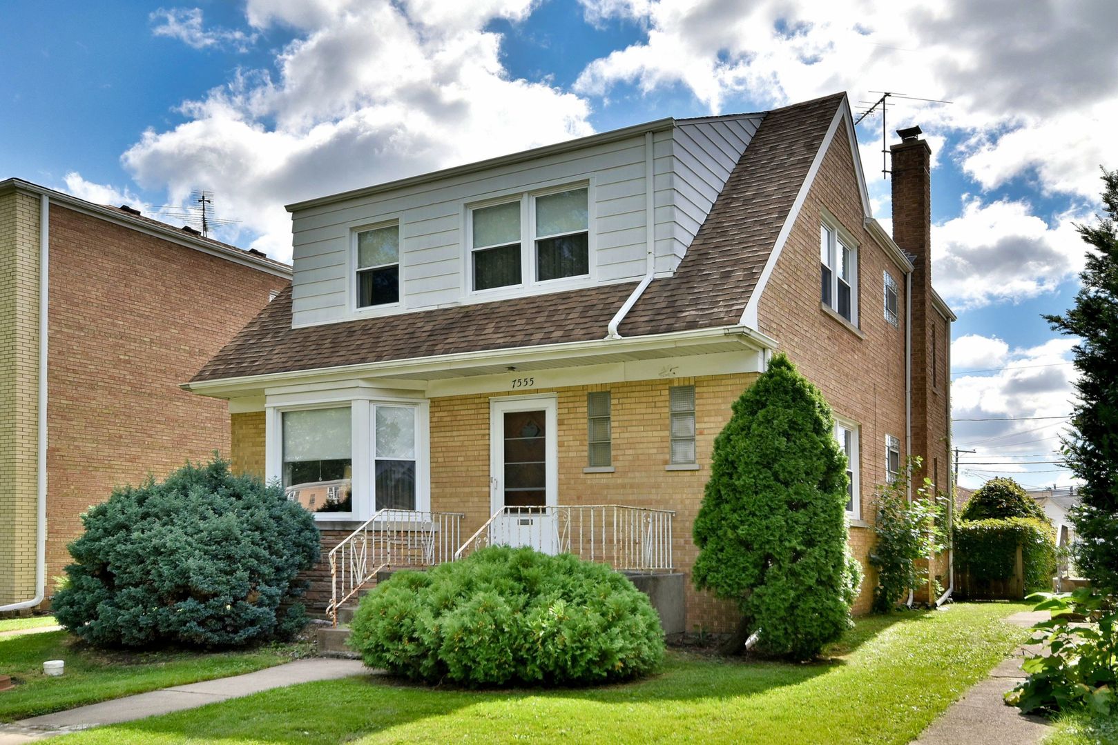 7555 Monroe Street Niles, IL 60714 - Photo 3 of 41 a view of a house with brick walls and a yard with plants