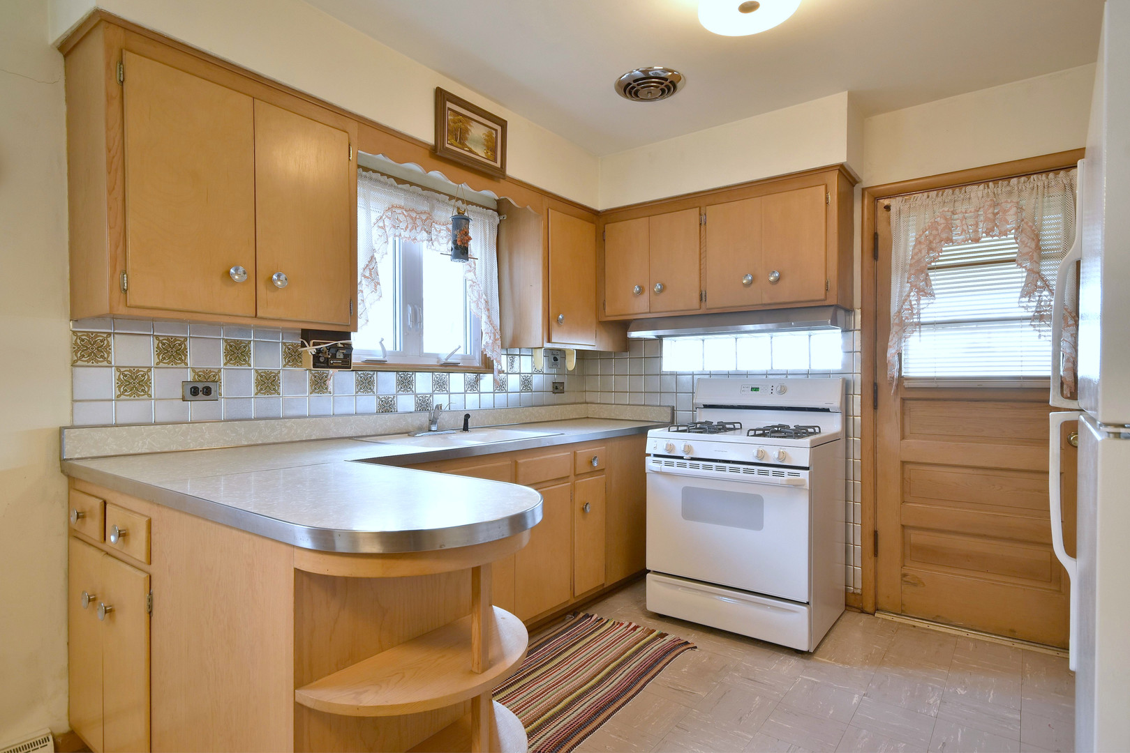7555 Monroe Street Niles, IL 60714 - Photo 32 of 41 a kitchen with stainless steel appliances a sink cabinets and a window