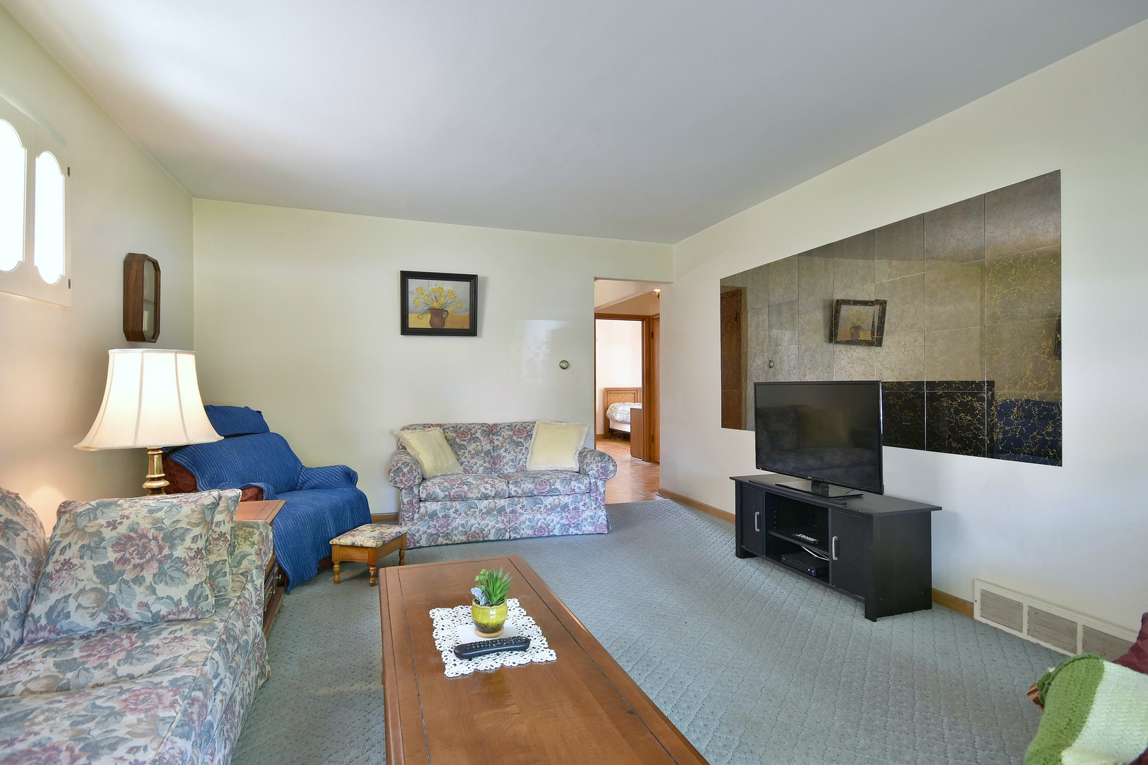 7555 Monroe Street Niles, IL 60714 - Photo 5 of 41 a living room with furniture and a flat screen tv