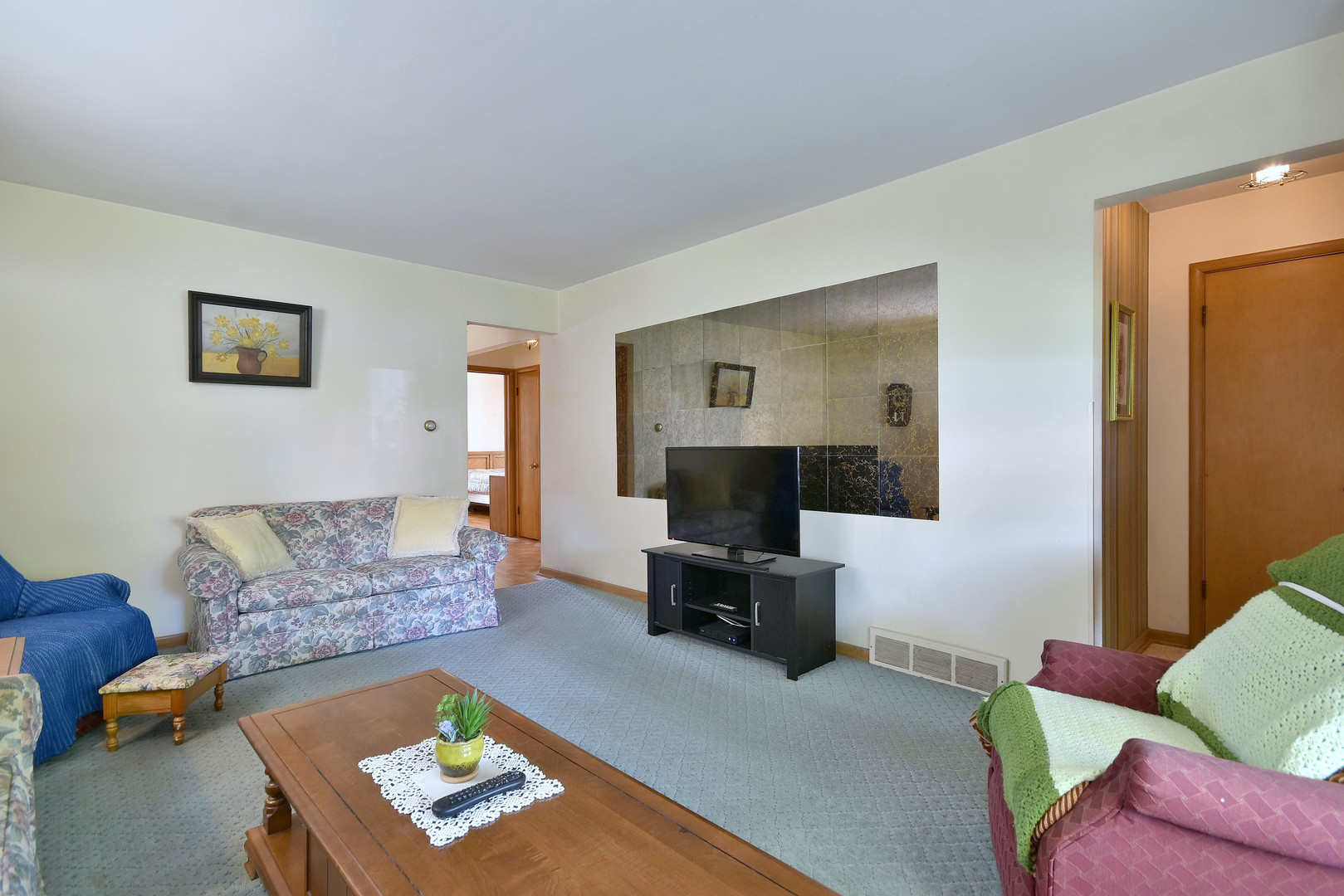 7555 Monroe Street Niles, IL 60714 - Photo 8 of 41 a living room with furniture and a flat screen tv