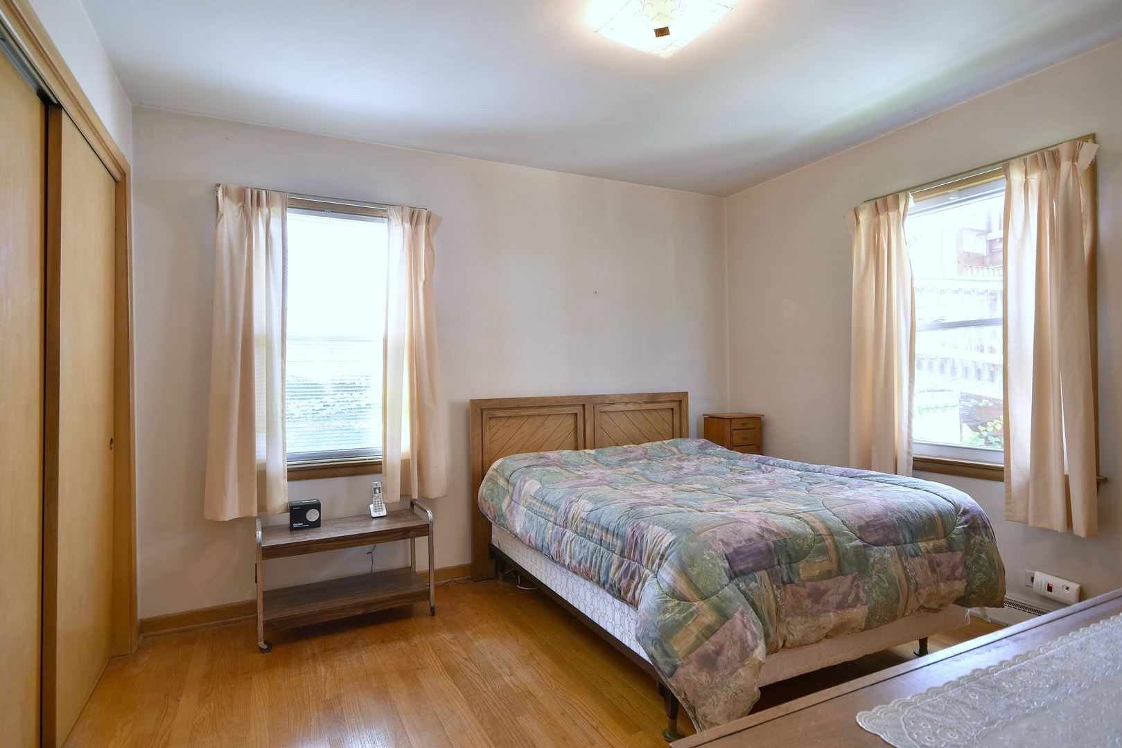 7555 Monroe Street Niles, IL 60714 - Photo 9 of 41 a bedroom with a bed and a window