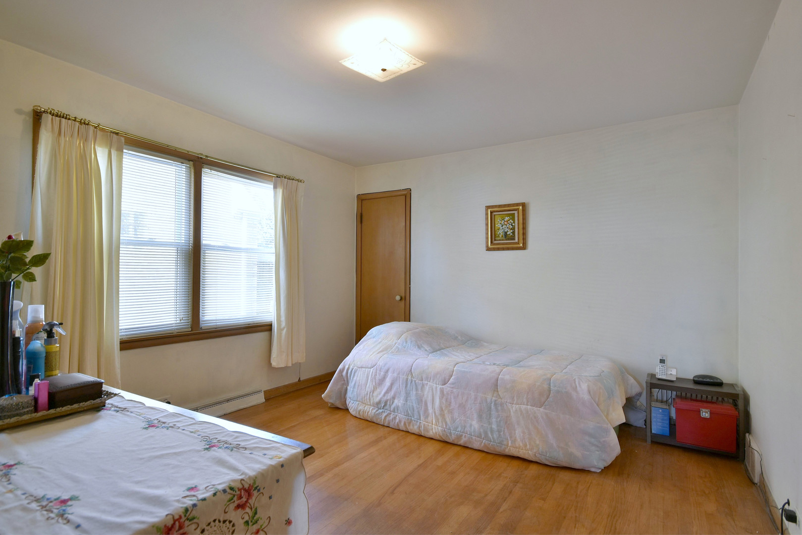 7555 Monroe Street Niles, IL 60714 - Photo 10 of 41 a bedroom with a bed and window