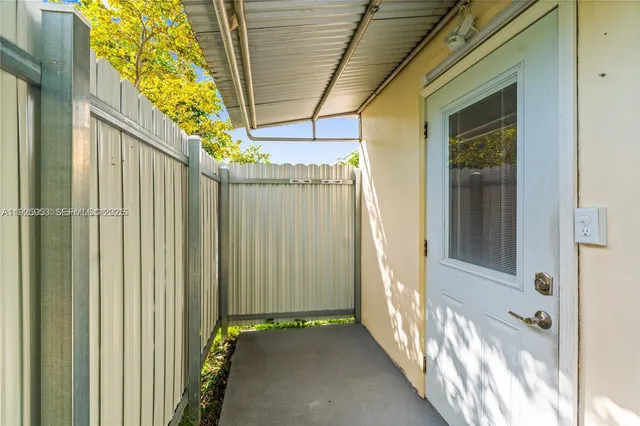 a view of a room with a door and wooden floor