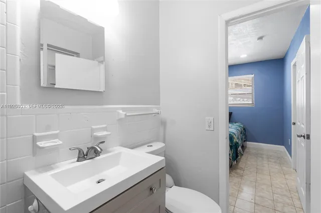 a bathroom with a sink mirror and toilet