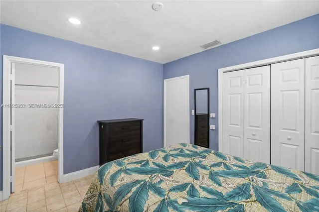 a bedroom with a bed and a mirror