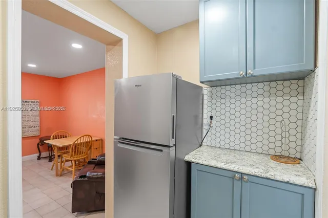 a kitchen with stainless steel appliances granite countertop a refrigerator and a sink