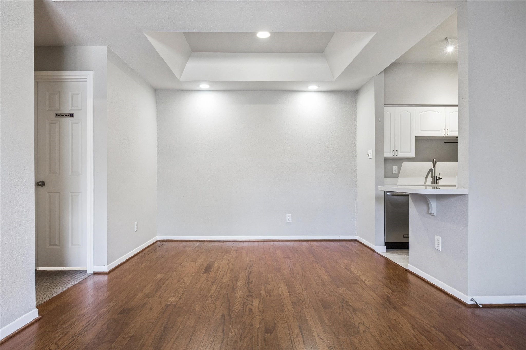 4041 Drake Street, Unit 113 Houston, TX 77005 - Photo 5 of 16 a view of a kitchen with a sink and wooden floor