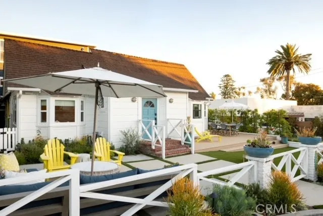 a view of a patio with chairs and umbrellas on the terrace