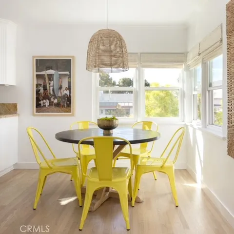 a dining room with furniture and a window