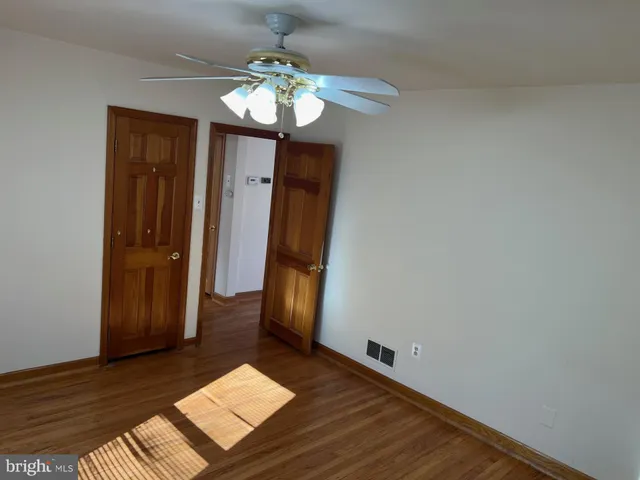 a view of a room with wooden floor and staircase