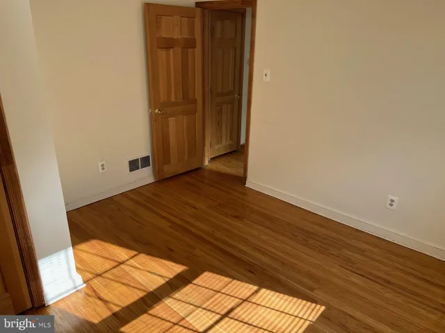 a view of a room with wooden floor