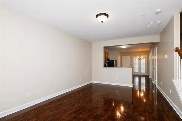 a view of a room with wooden floor