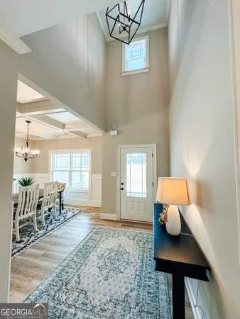 a view of a hallway with wooden floor and staircase