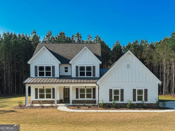 a view of a bedroom with wooden floor and furniture