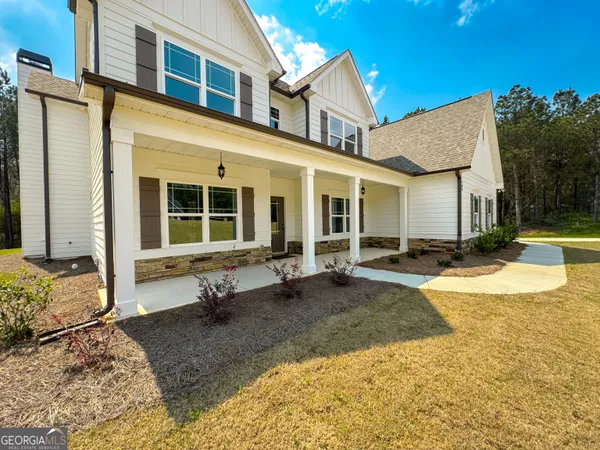a view of a hallway with wooden floor and entryway