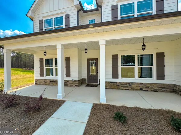 a large bathroom with a granite countertop sink a large mirror and a shower