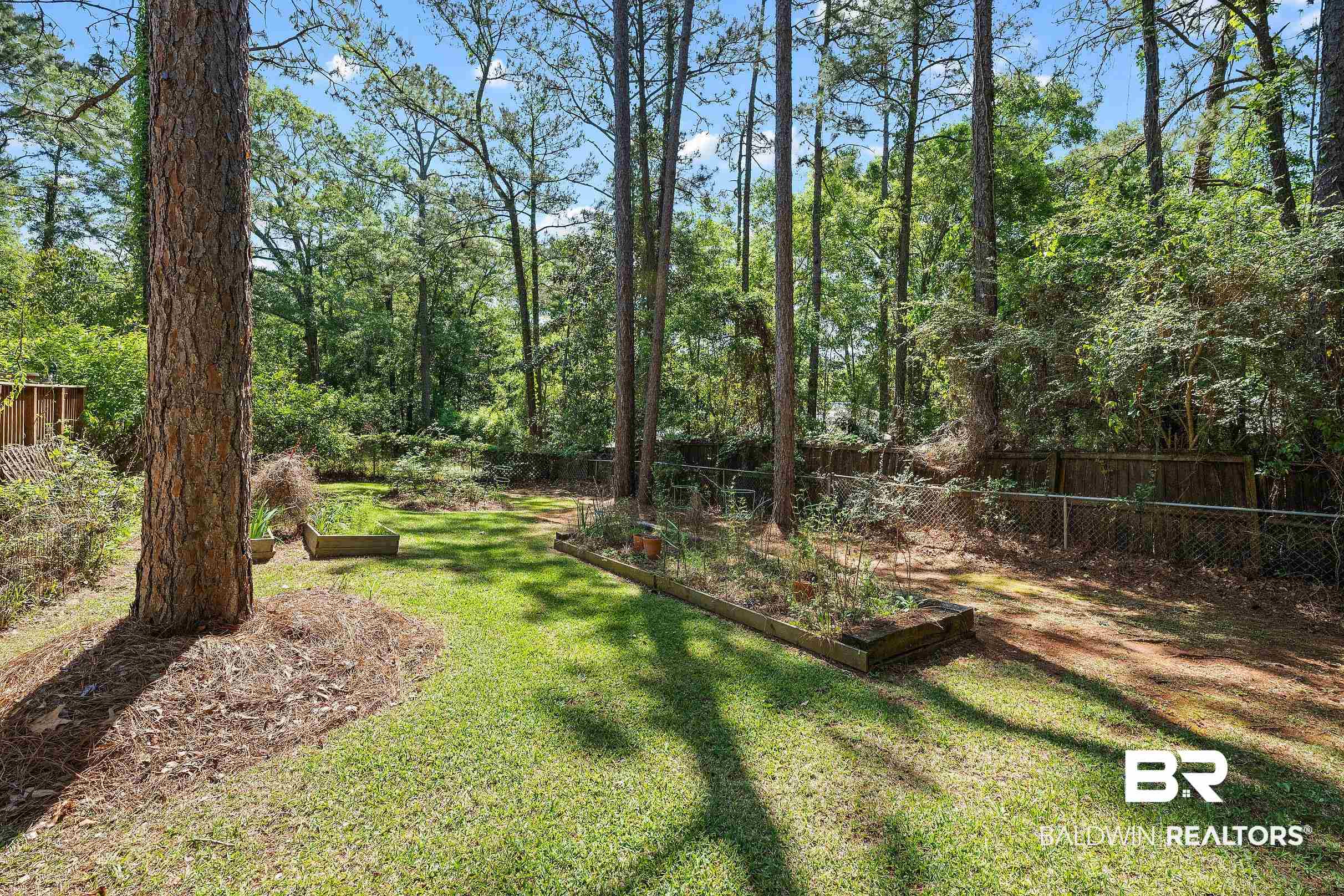 120 Dunbar Loop Daphne, AL 36526 - Photo 23 of 25 Fenced backyard featuring a vegetable garden