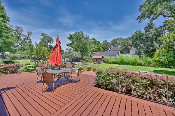 a view of a chairs and table on the deck with wooden floor