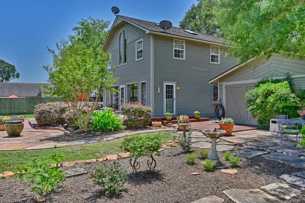 a backyard of a house with table and chairs