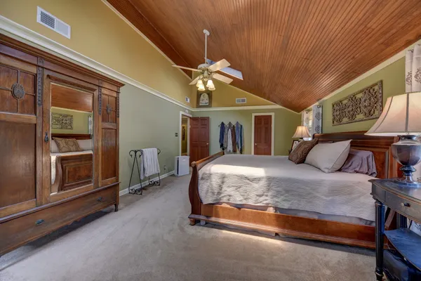 a bed room with a bed and a chandelier