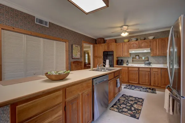 a kitchen with a sink stove and cabinets