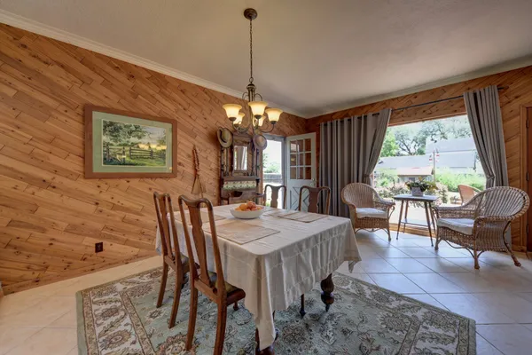 a view of a dining room with furniture and chandelier