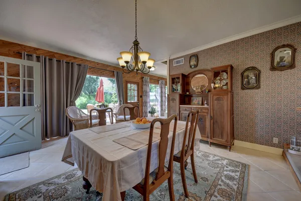 a dining room with furniture and window