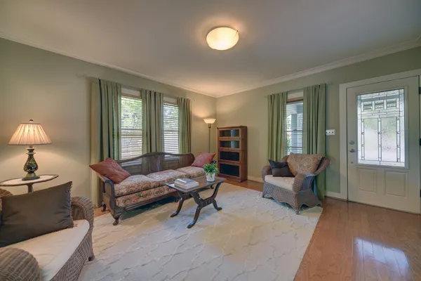 a living room with furniture and a wooden floor