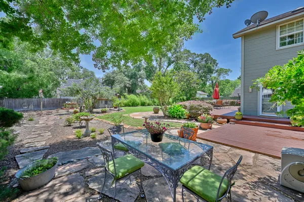 a view of a backyard with sitting area and garden