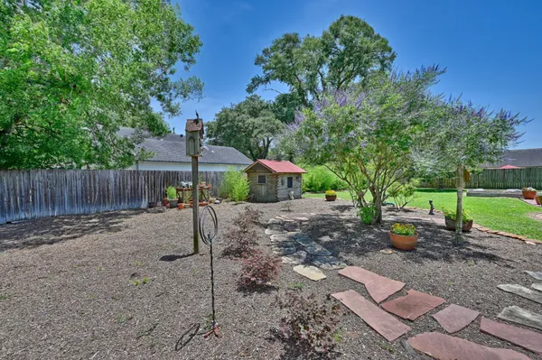 a view of a backyard with large tree