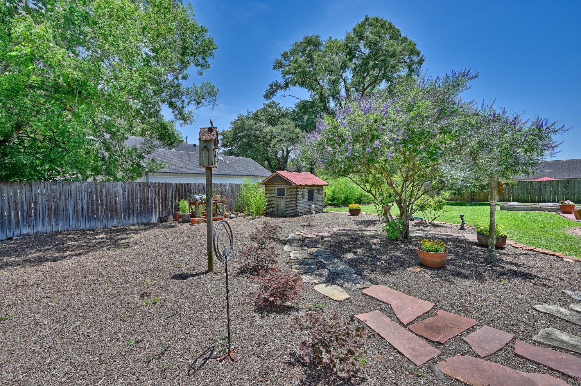 1026 Atchison Street Sealy, TX 77474 - Photo 8 of 50 a view of a backyard with large tree