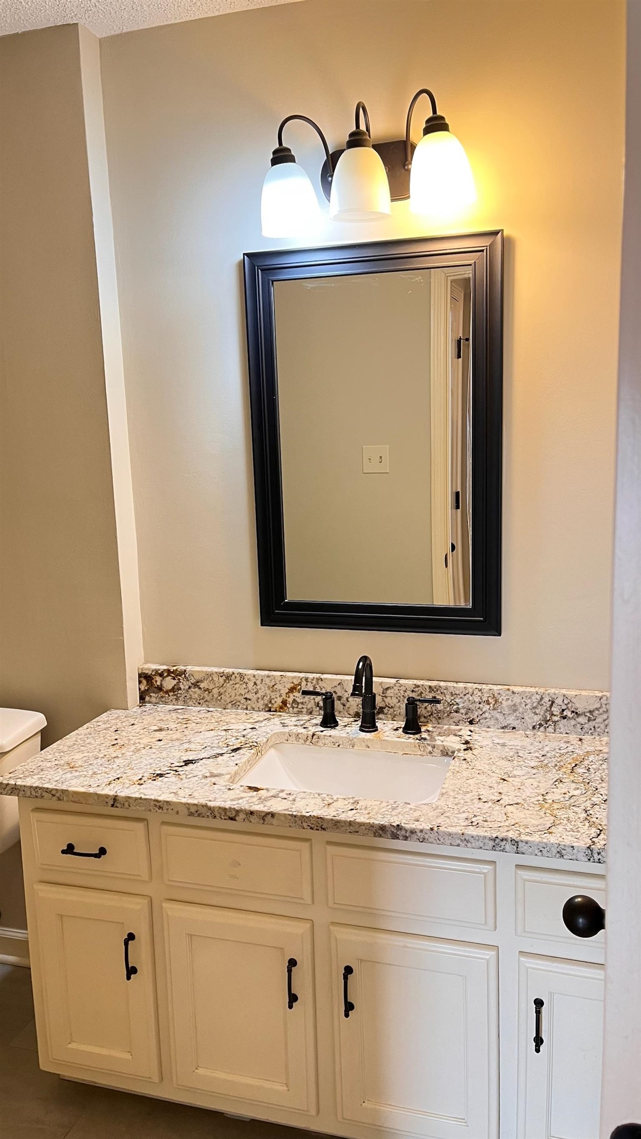 7770 Juniper Cove West Memphis, TN 38016 - Photo 2 of 34 Half bathroom with vanity and dark tile patterned floors