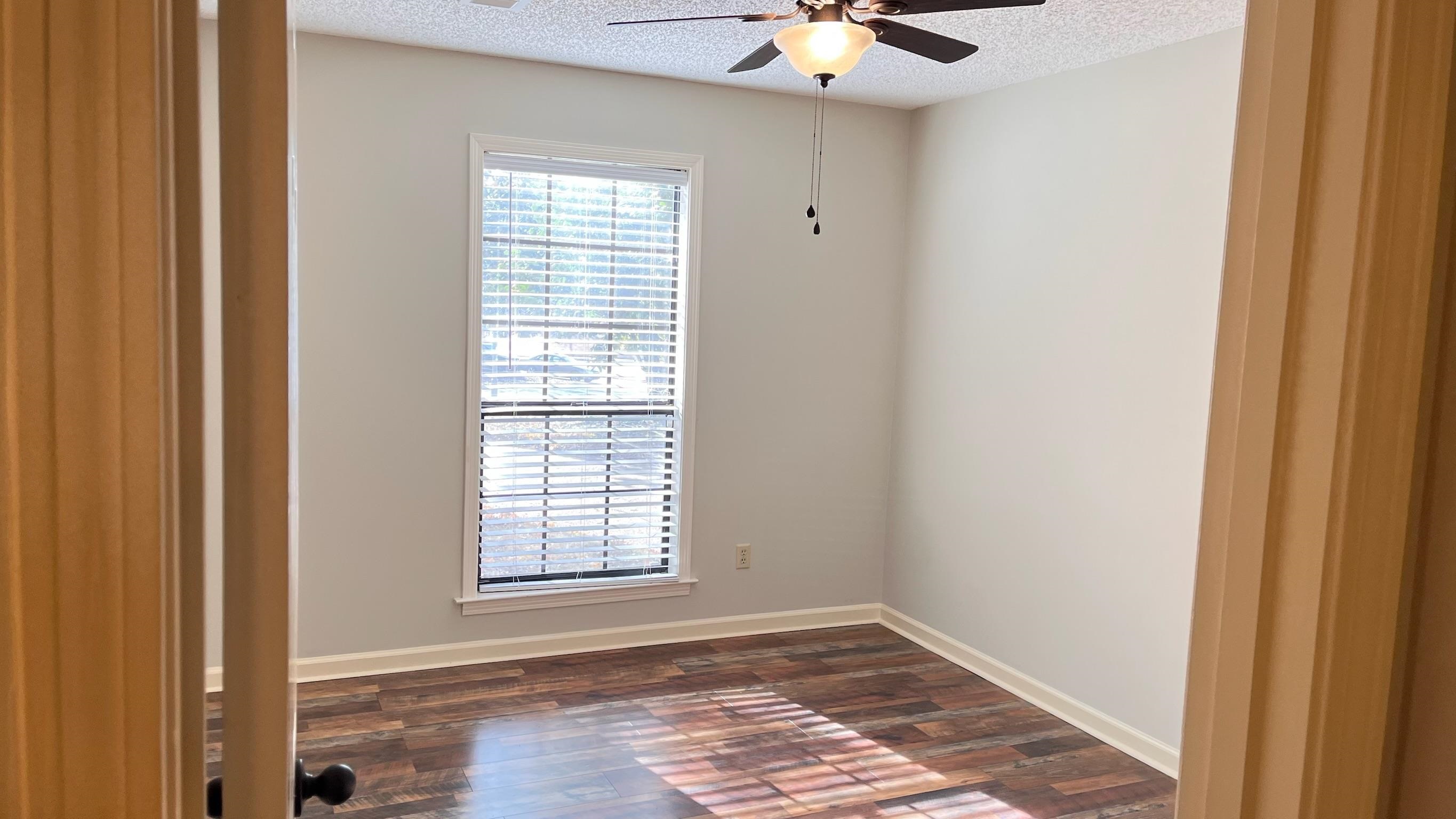 7770 Juniper Cove West Memphis, TN 38016 - Photo 29 of 34 Empty room with dark wood-style floors, a textured ceiling, and a ceiling fan