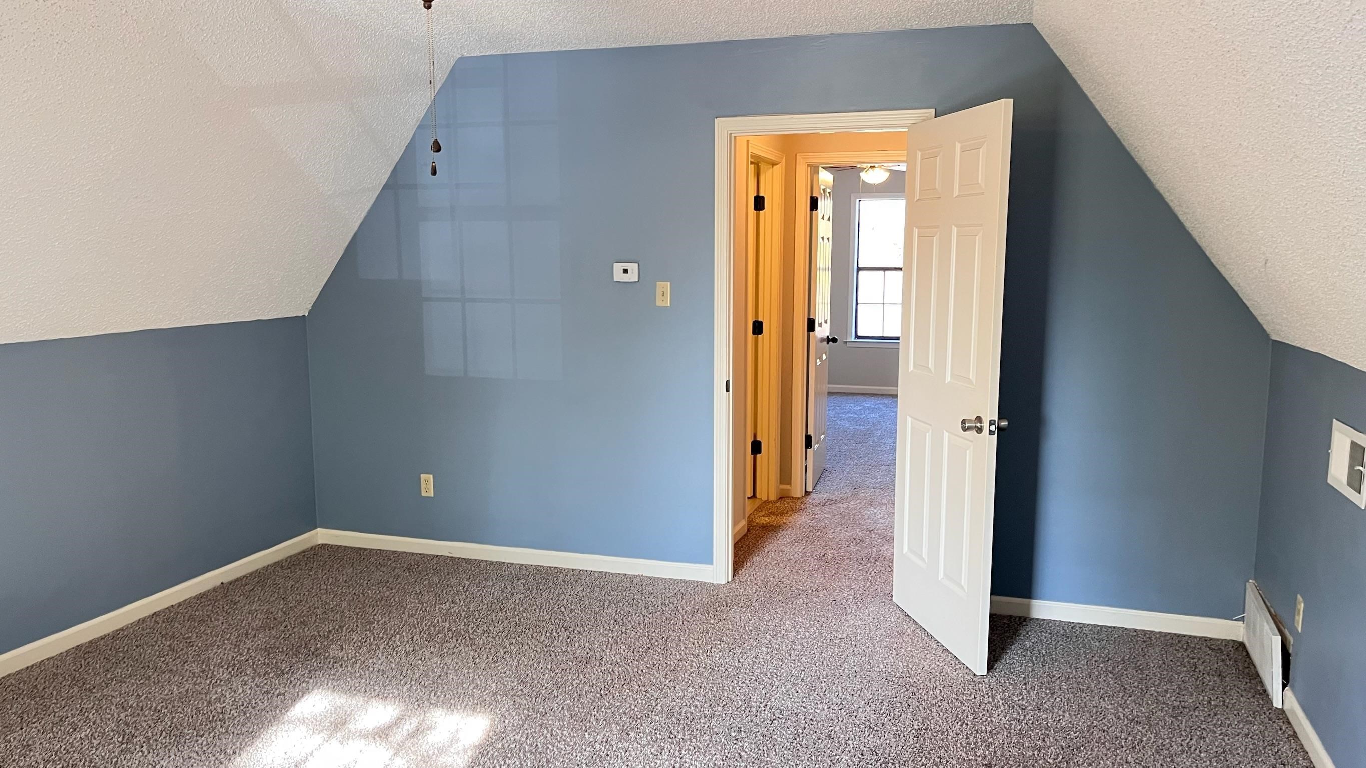 7770 Juniper Cove West Memphis, TN 38016 - Photo 3 of 34 4th Bedroom room with a textured ceiling, lofted ceiling, and carpet floors
