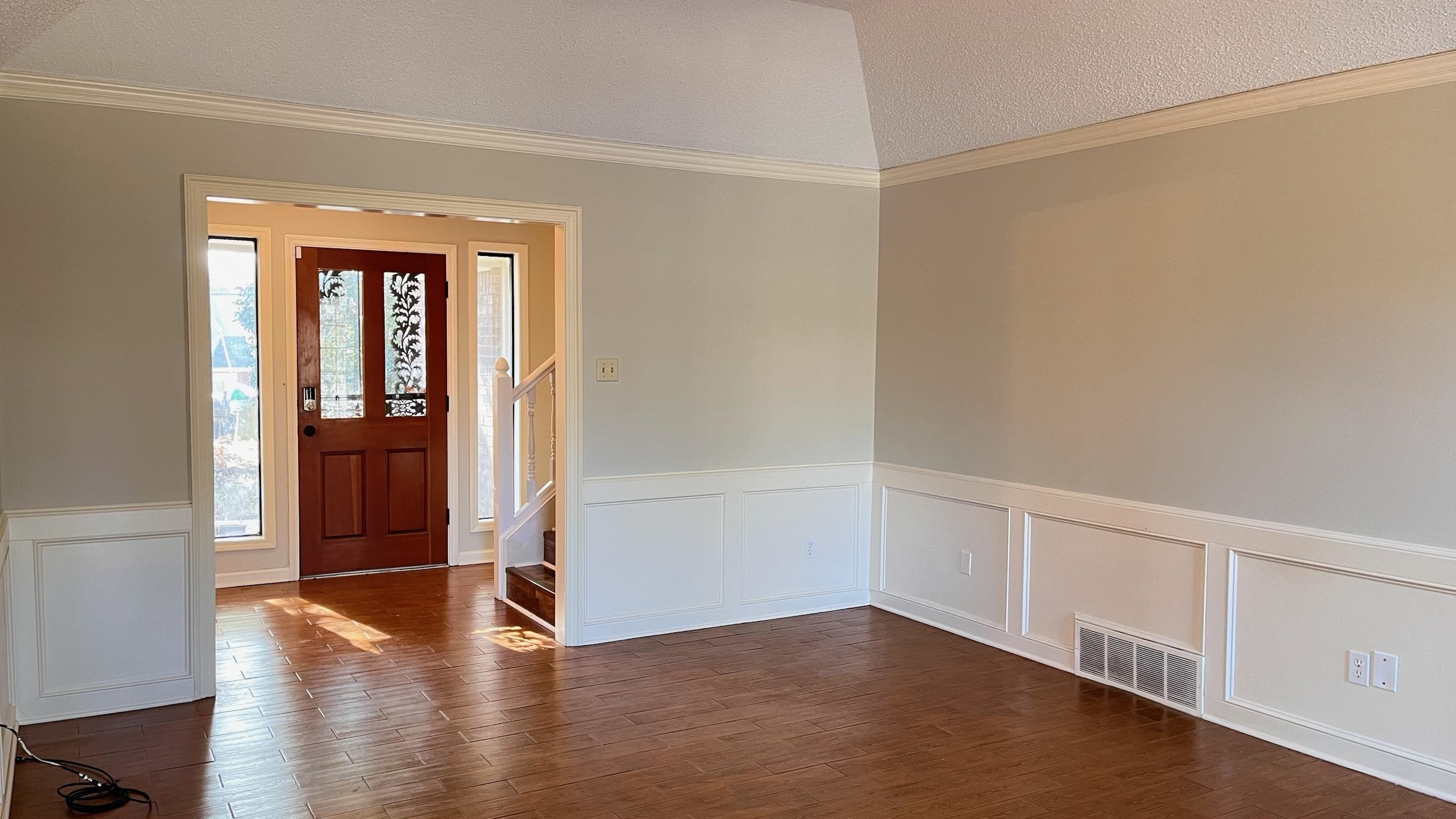7770 Juniper Cove West Memphis, TN 38016 - Photo 7 of 34 Entryway featuring a wainscoted wall, ornamental molding, a decorative wall, dark wood-type flooring, and stairway