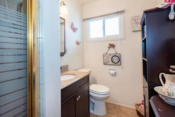 a bathroom with a toilet a sink and a window