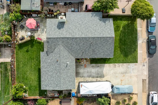 an aerial view of a house with table and chairs