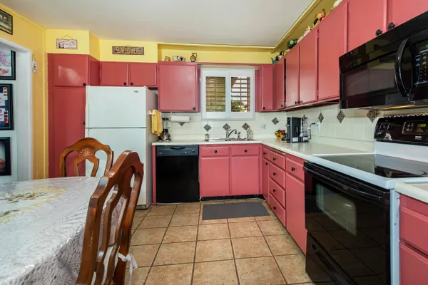 a kitchen with stainless steel appliances granite countertop a stove top oven a sink dishwasher and a microwave
