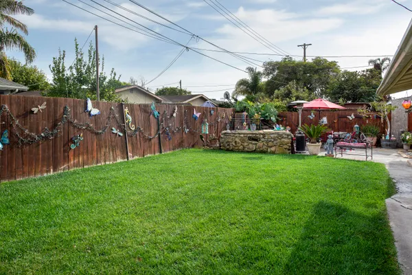 a view of a yard with a house in the background