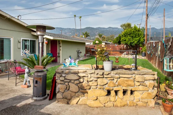 a view of a patio with table and chairs potted plants