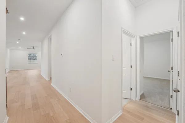 a view of a hallway with a bathroom