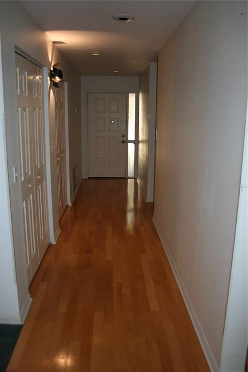 3706 Northeast 16th Place Ocala, FL 34470 - Photo 5 of 14 a view of a hallway with wooden floor