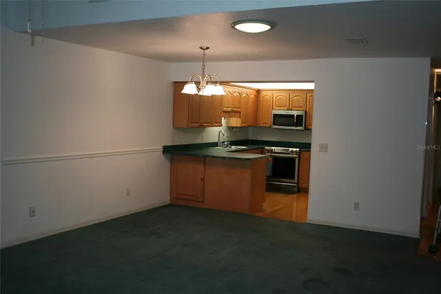 a kitchen with stainless steel appliances a stove and a refrigerator