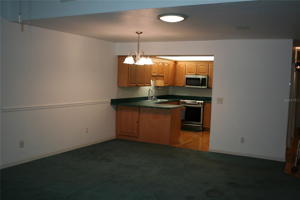 3706 Northeast 16th Place Ocala, FL 34470 - Photo 7 of 14 a kitchen with stainless steel appliances a stove and a refrigerator