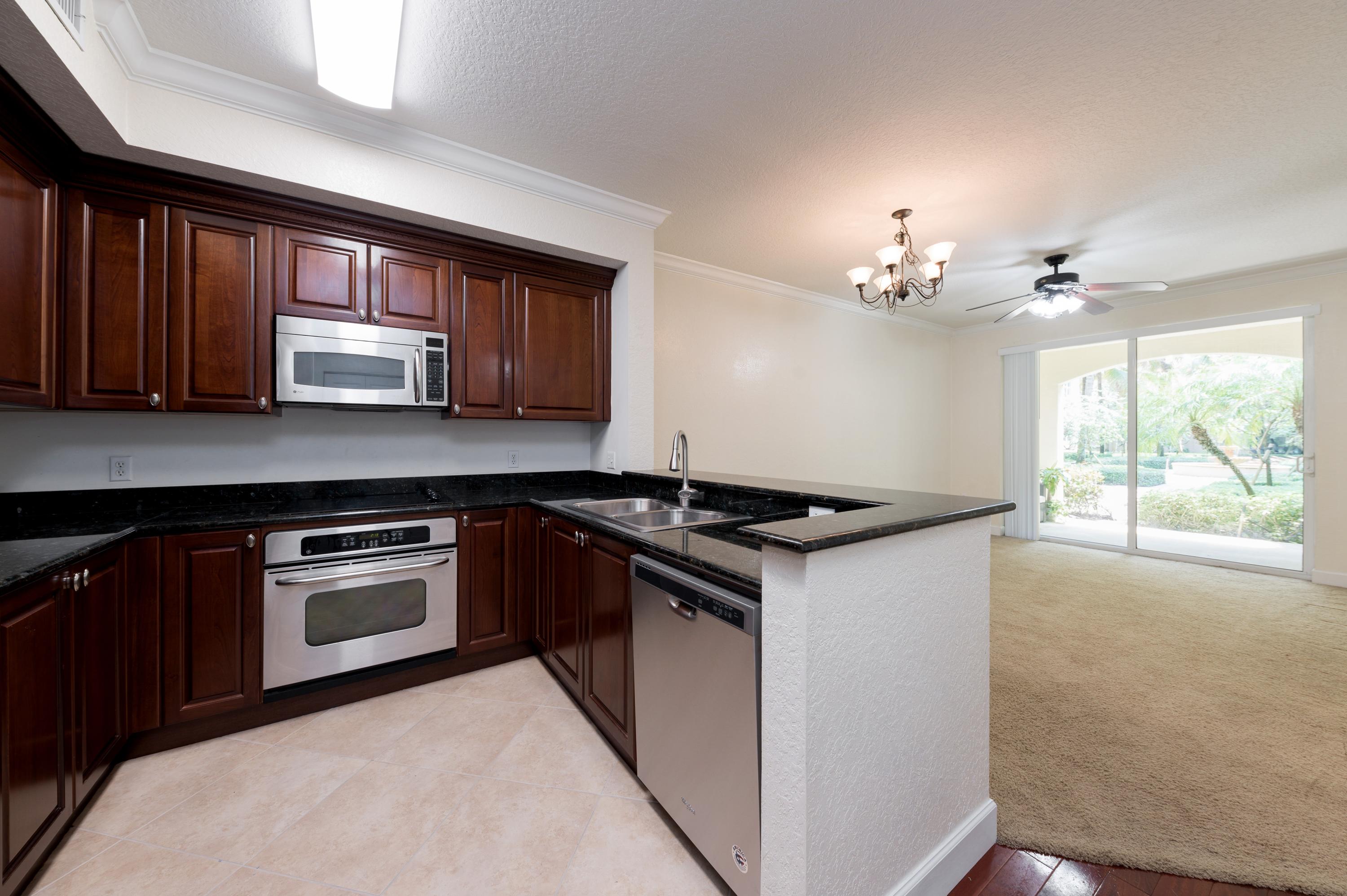 1116 Renaissance Way, Unit 116 Boynton Beach, FL 33426 - Photo 3 of 12 07_1116RenaissanceWay_91_KitchenLivingRo