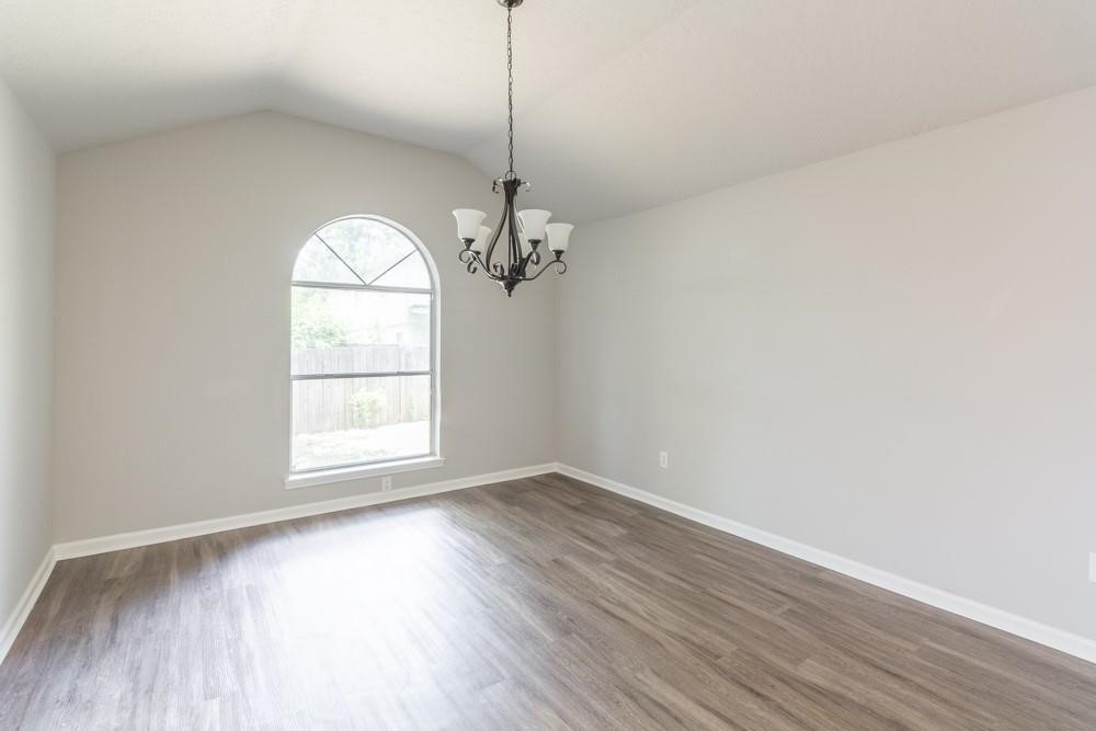 2007 Ruffian Lane Stafford, TX 77477 - Photo 8 of 17 wooden floor in an empty room with a window