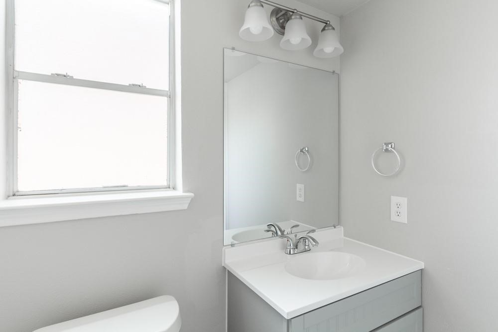 2007 Ruffian Lane Stafford, TX 77477 - Photo 9 of 17 a bathroom with a sink mirror and toilet