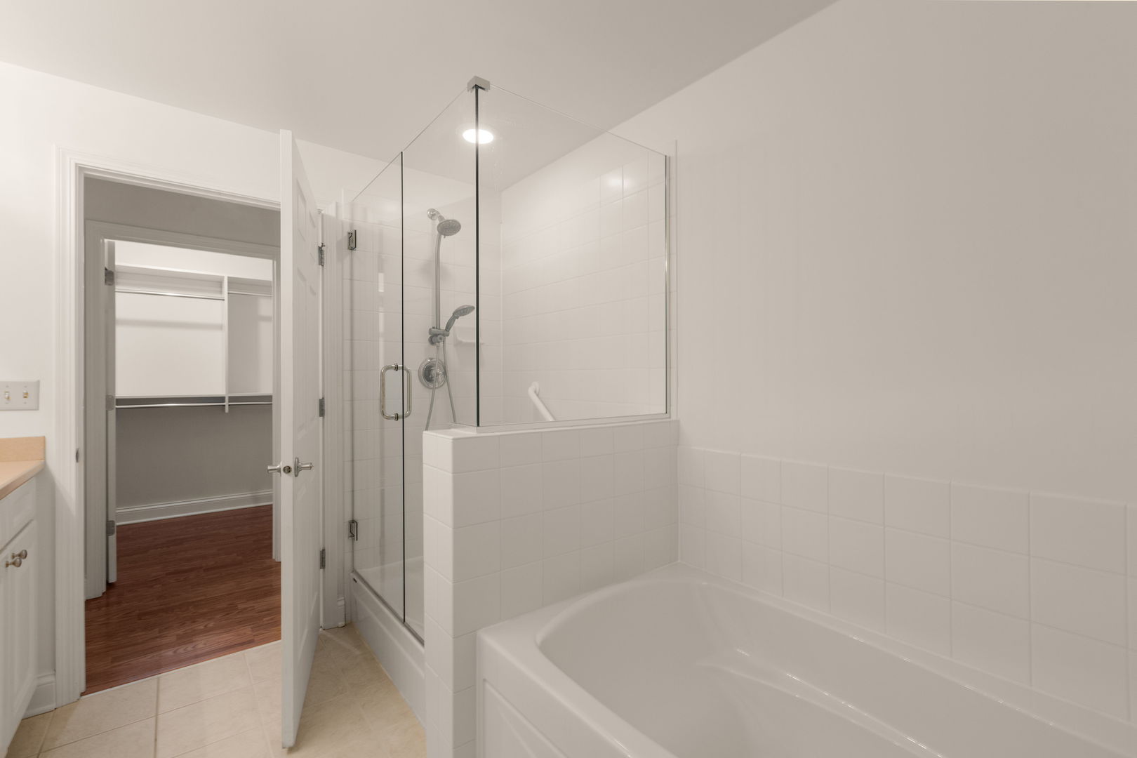 125 North Buffalo Grove Road, Unit 104 Buffalo Grove, IL 60089 - Photo 11 of 17 a bathroom with a bathtub and a shower