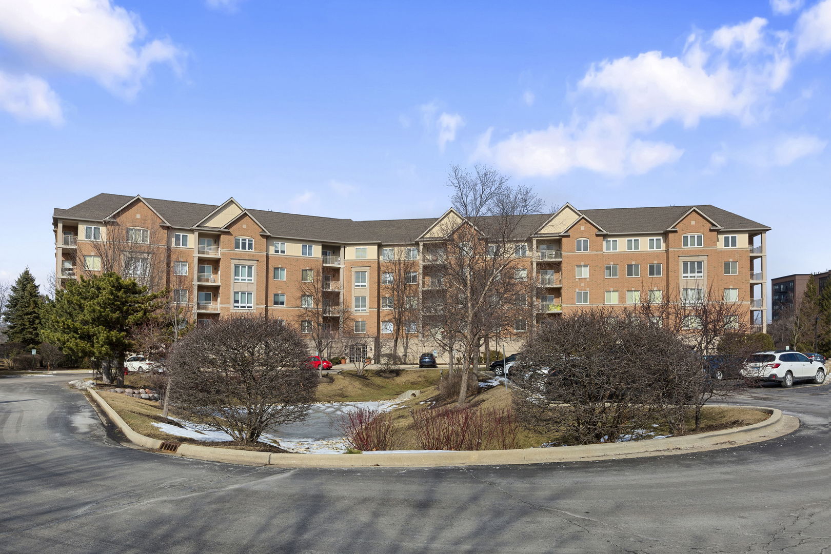 125 North Buffalo Grove Road, Unit 104 Buffalo Grove, IL 60089 - Photo 2 of 17 a front view of a house with a yard