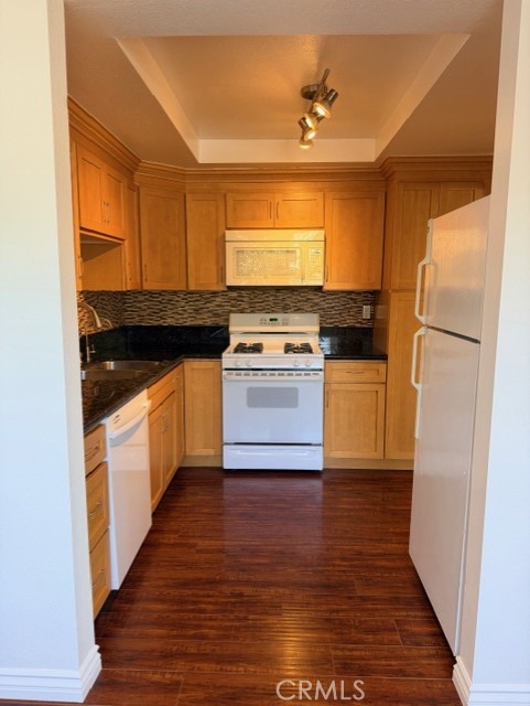 2500 East 4th Street, Unit 203 Long Beach, CA 90814 - Photo 13 of 35 a kitchen with stainless steel appliances granite countertop a stove a sink and a refrigerator
